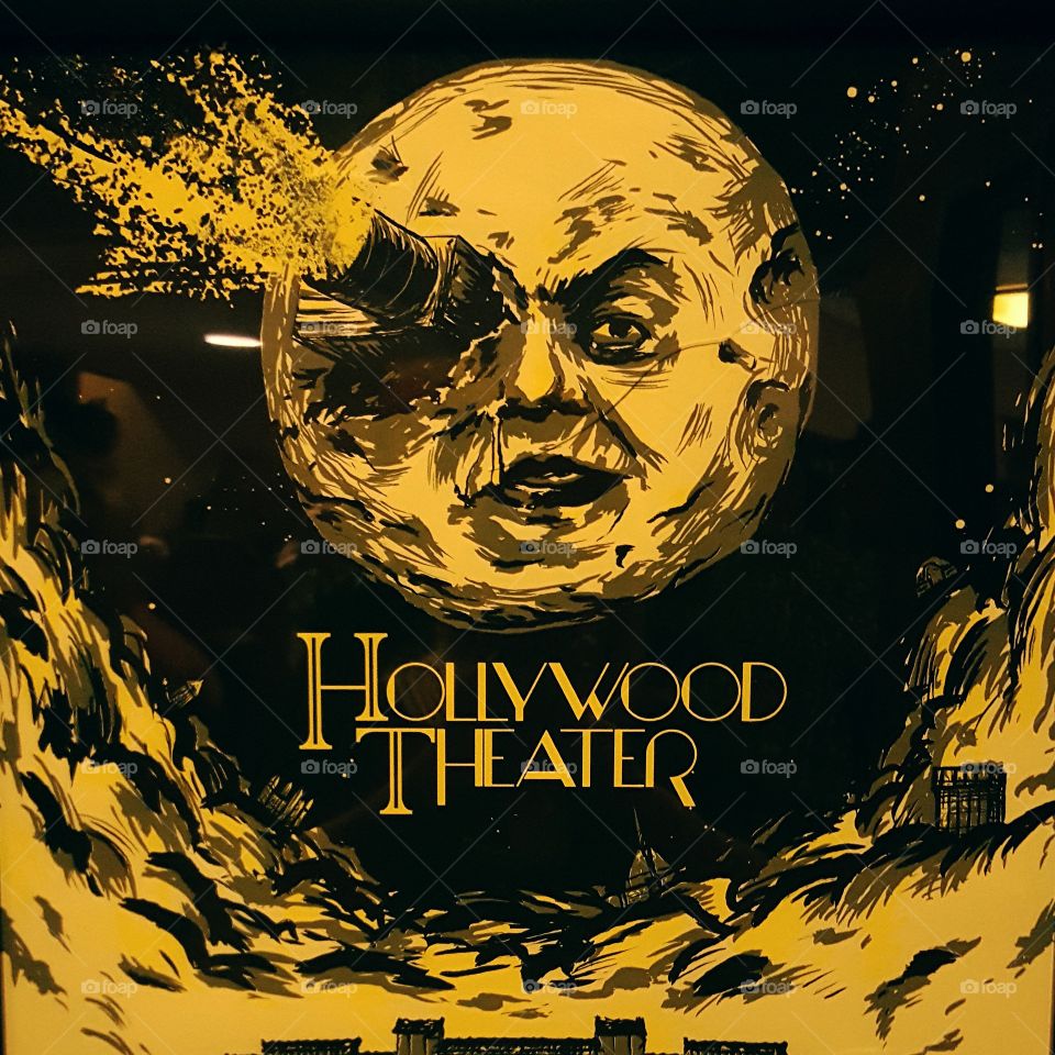 Hollywood theater poster with vintage man in the moon design.