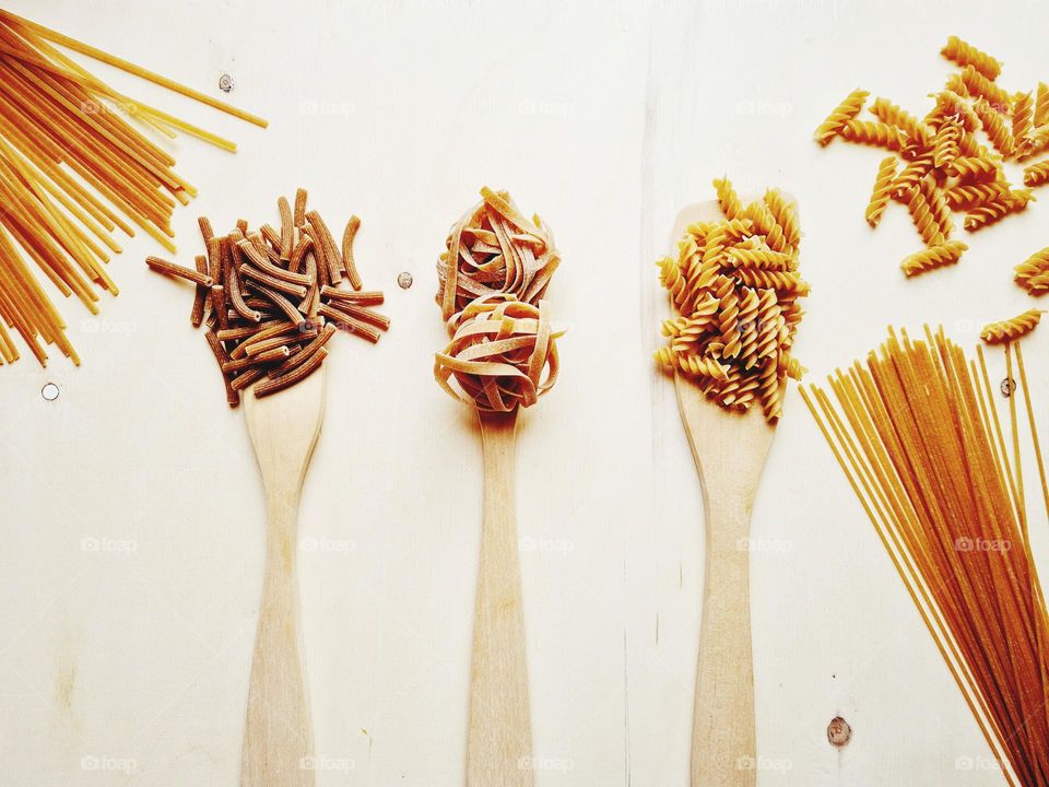 flat lay with various shapes of wholemeal pasta