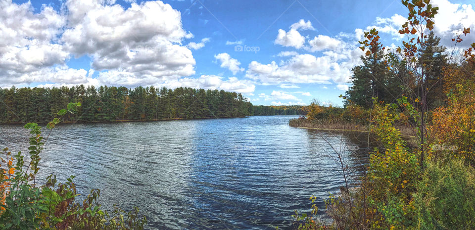 Lake surrounded by trees and clouds 