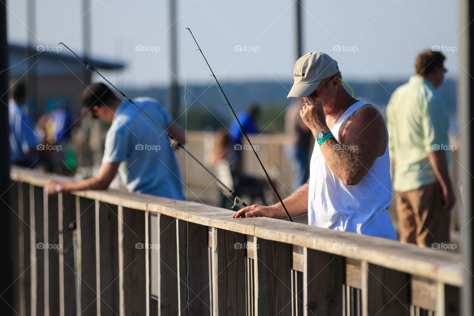 Man fishing at the sea port