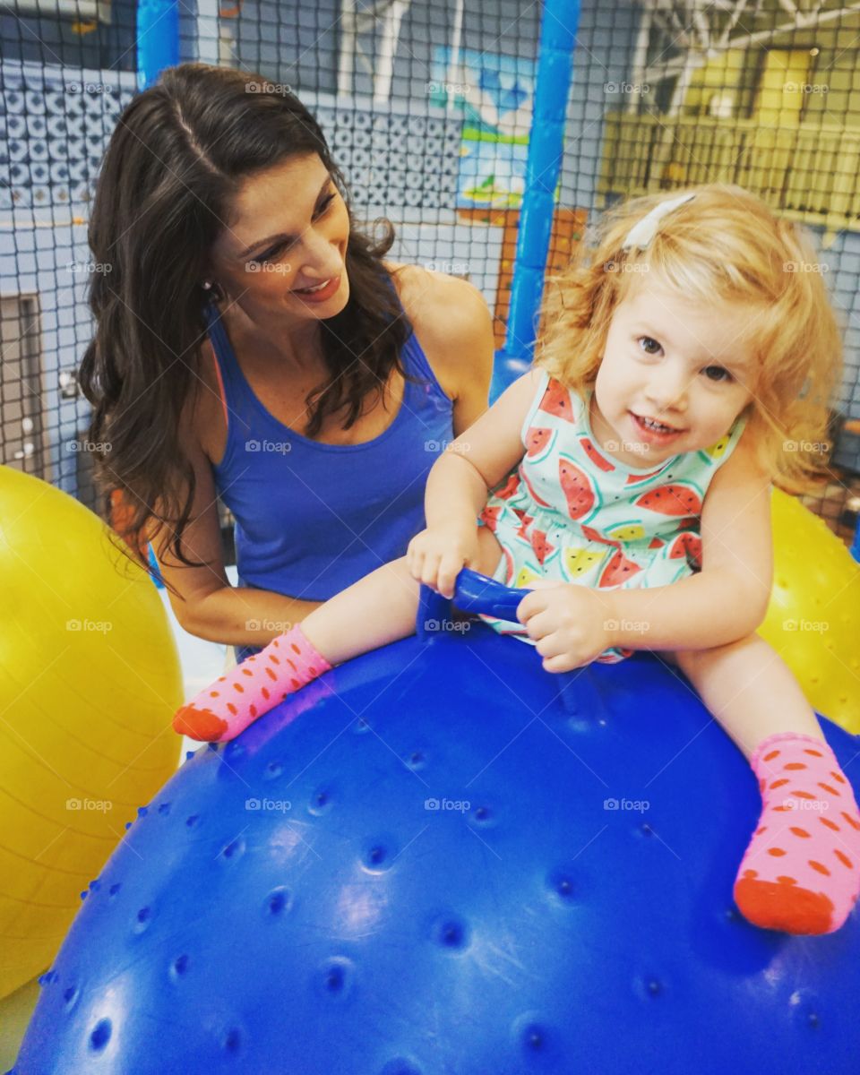 Cute girl sitting on ball