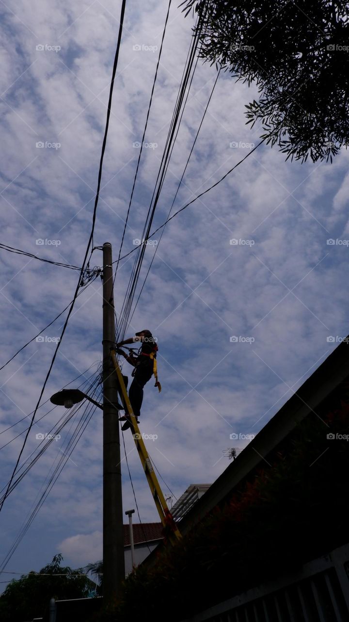 Human interest - A worker is repairing a street light