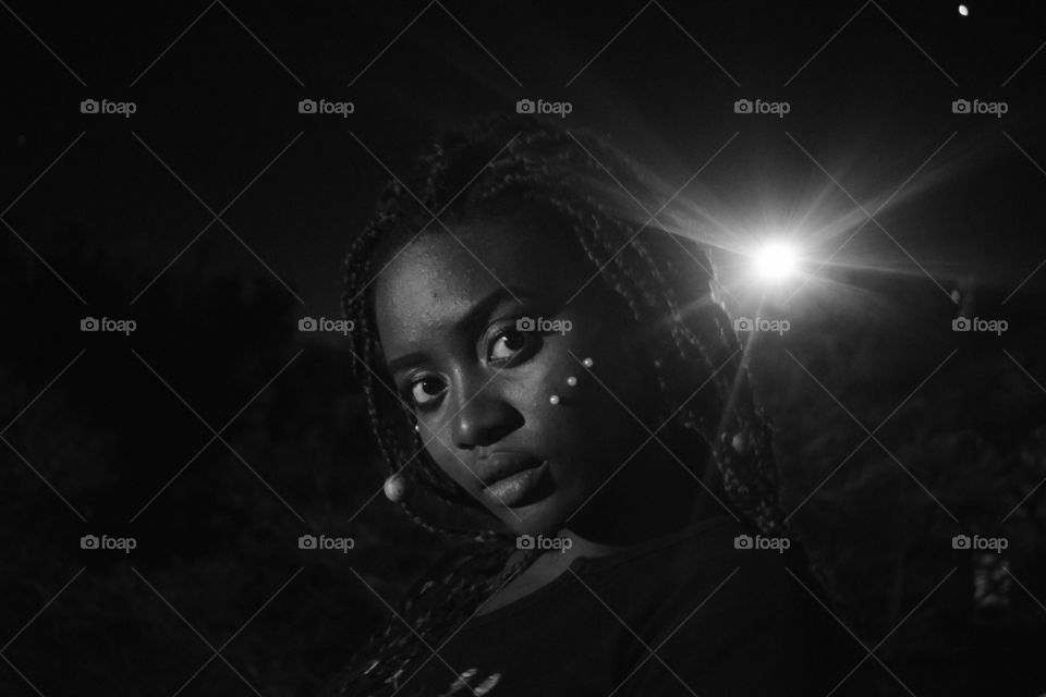 a black and white portrait of a beautiful dark skinned black African woman with tiny pearls on her face