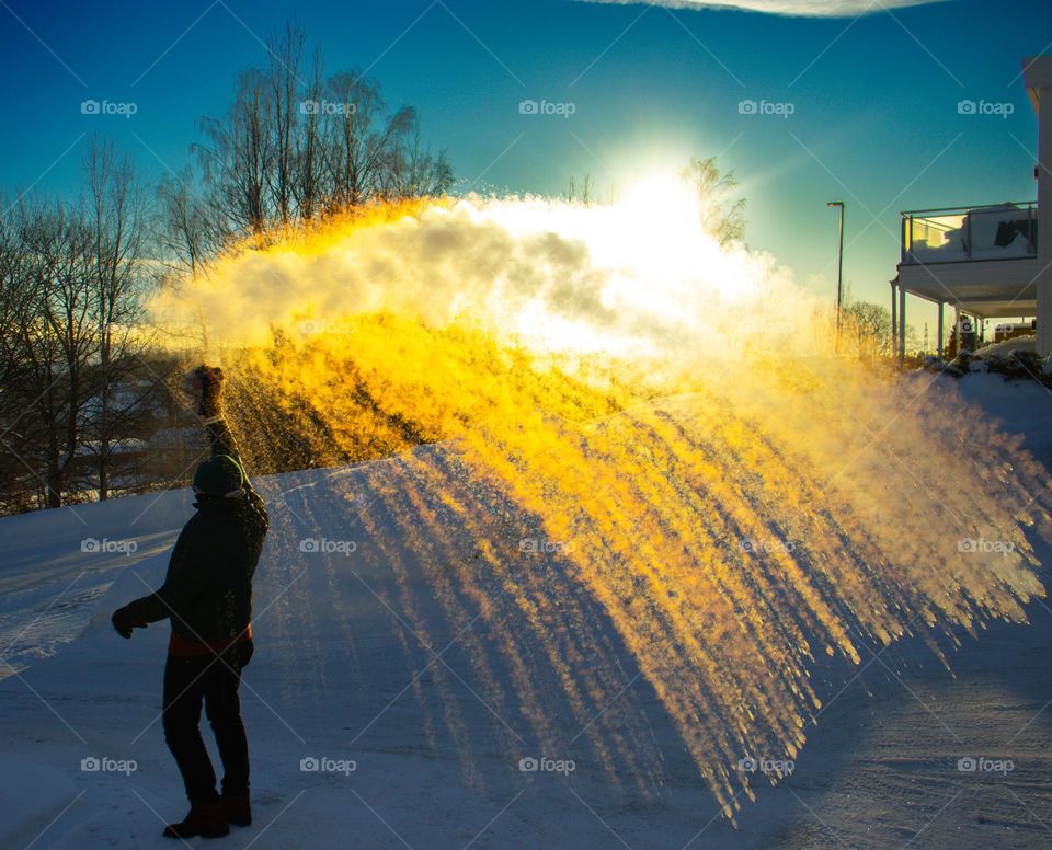 Winter fun in january.Hot water in the cold weather . Having fun in the winter weather .