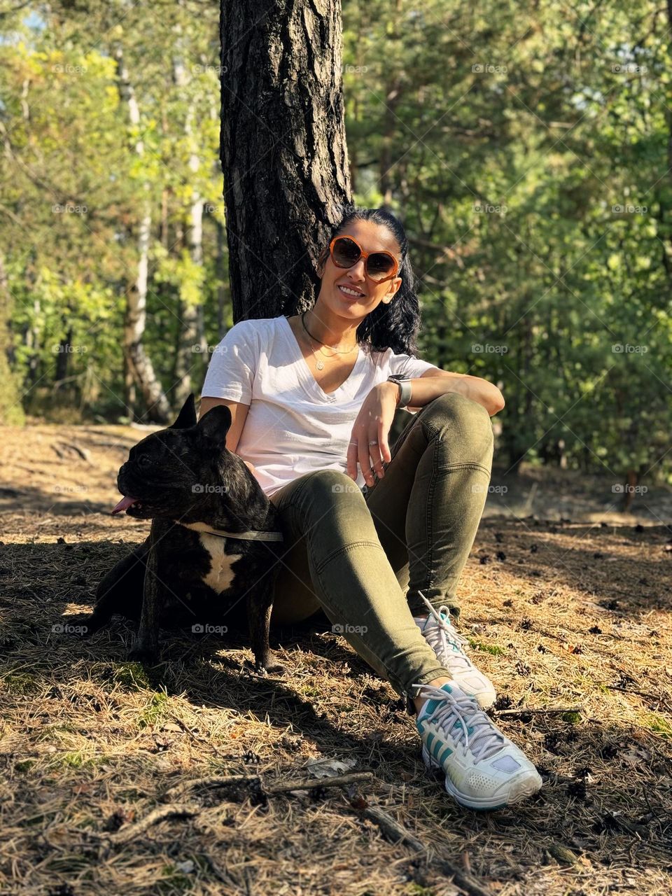 Woman and a dog in a forest