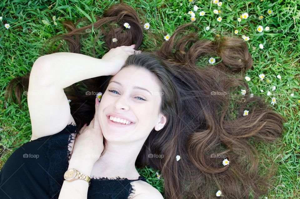 Smiling woman on a background of daisies