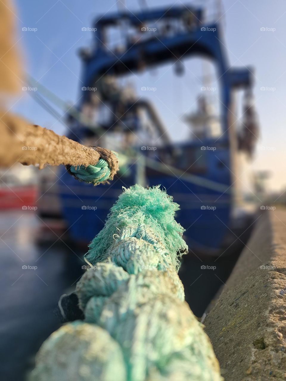 fishing boat moored with a rope in the port