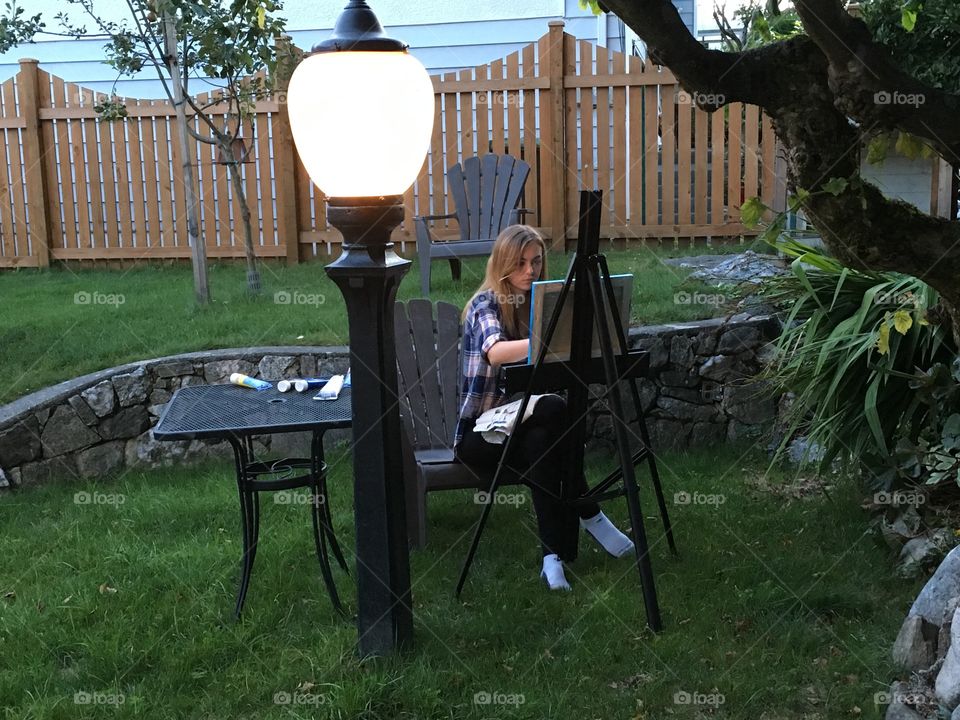 Artist painting outside 

