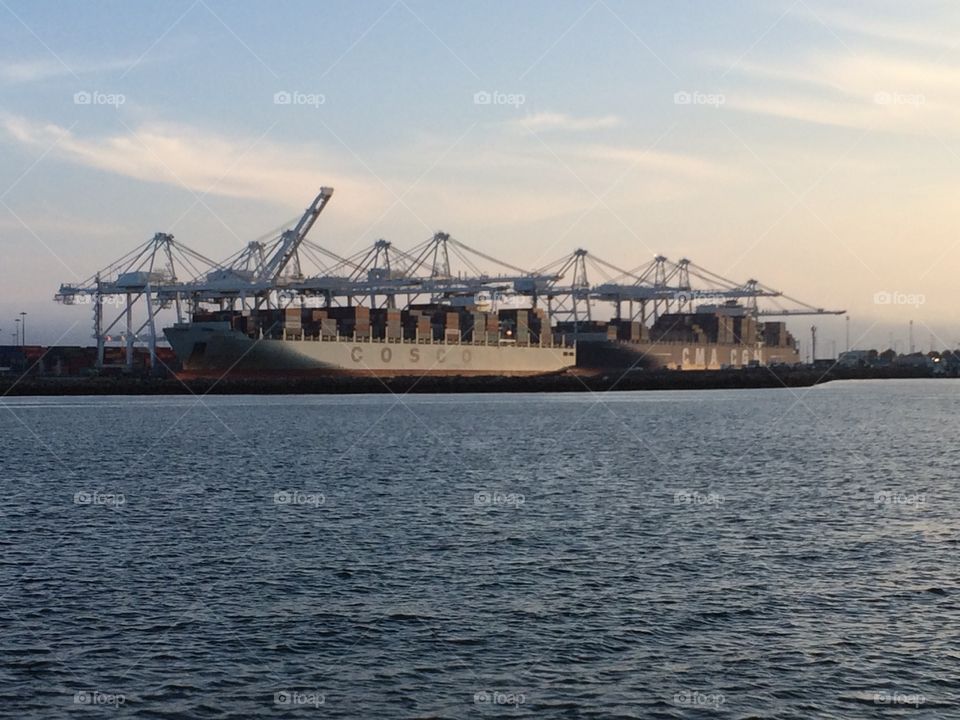 Port of Long Beach cargo ship and cranes 