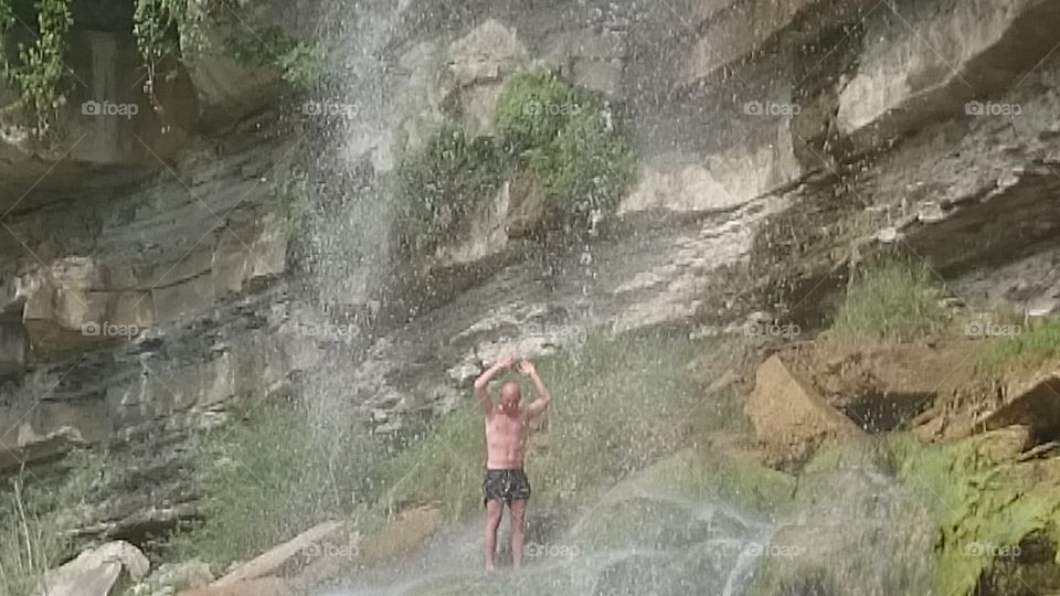 under the waterfall