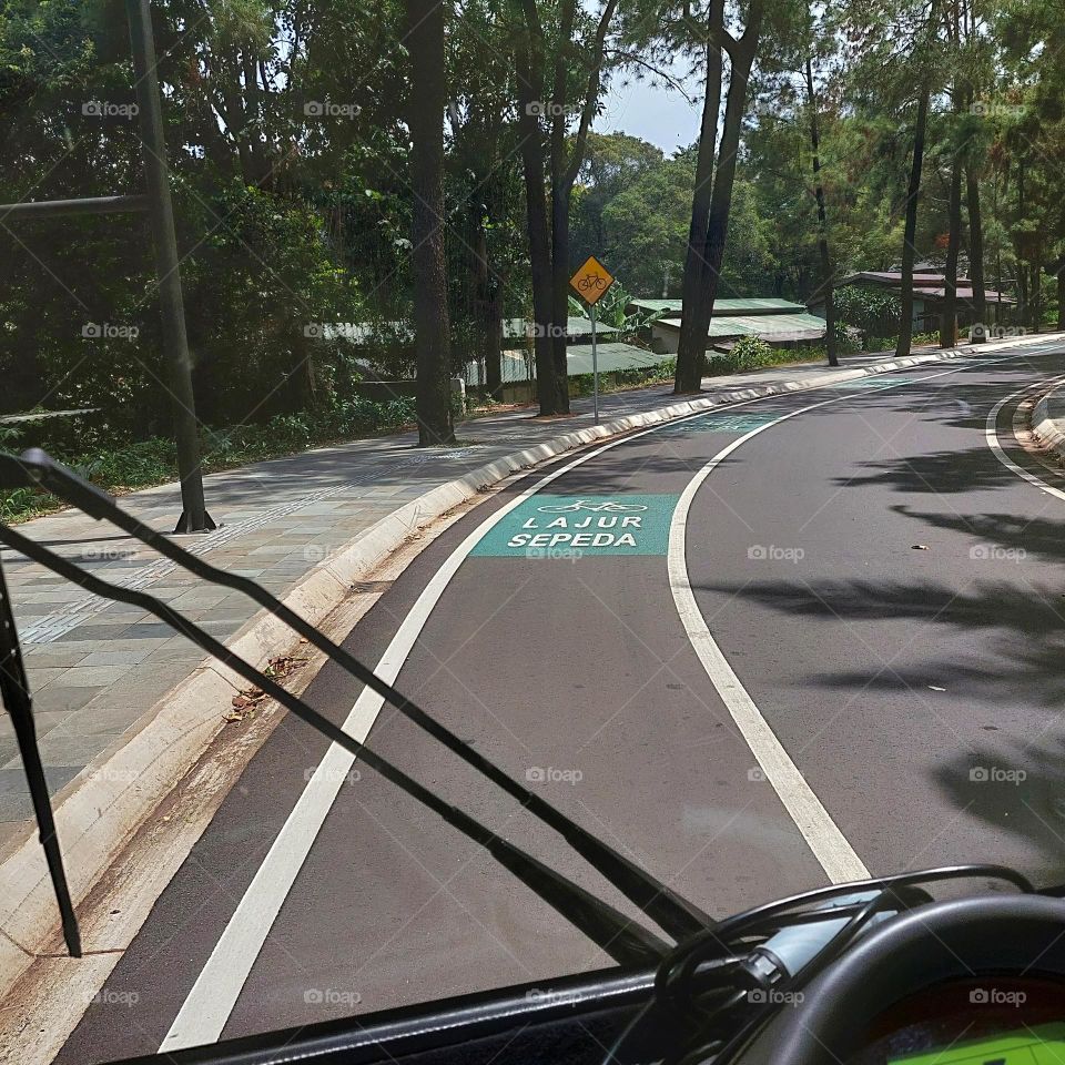 traveling by electric vehicle on empty streets with bicycle lanes on the side