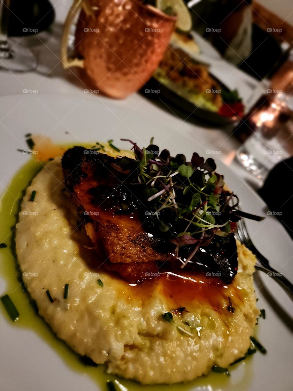 Pan seared salmon and yellow jalapeño grits with sweet Chilli broccolini