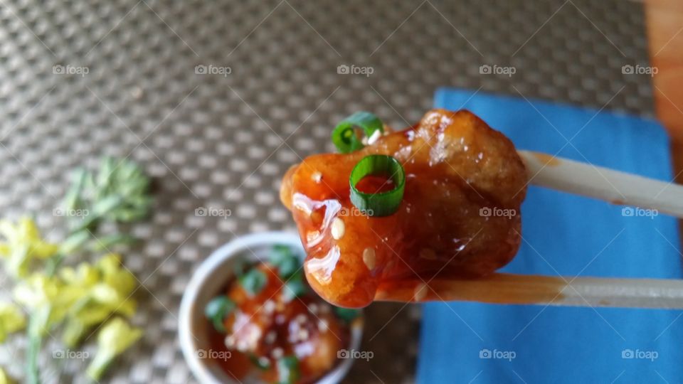 Close-up of a chicken in chopsticks