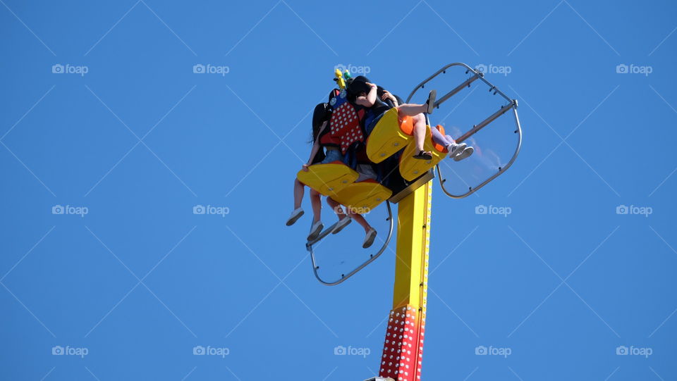 People enjoying a thrill ride in summer fair.
