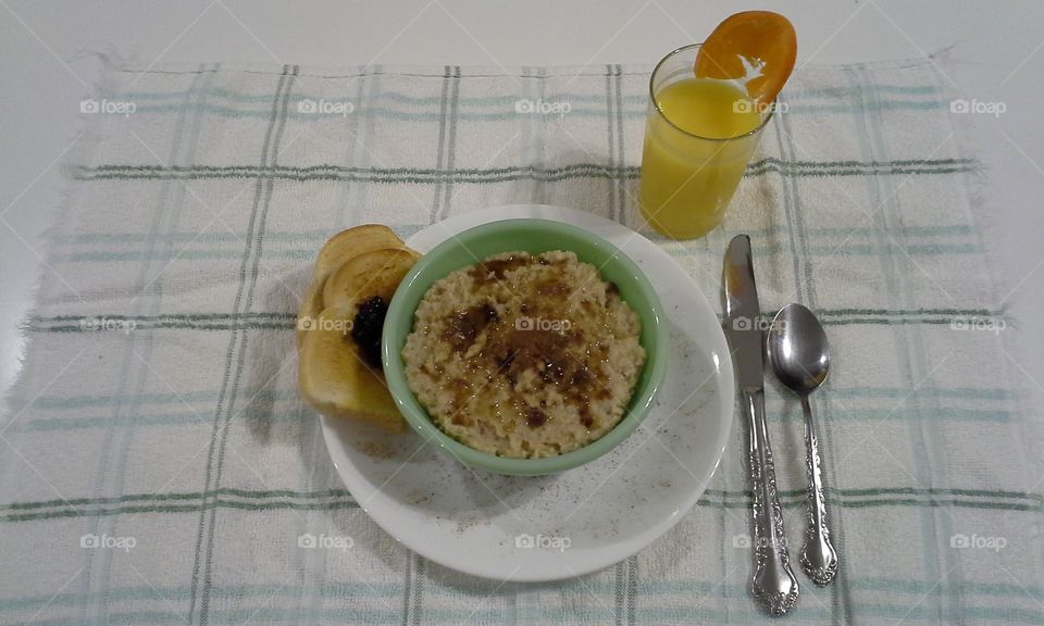 Cinnamon brown sugar oatmeal with orange juice toast and jam