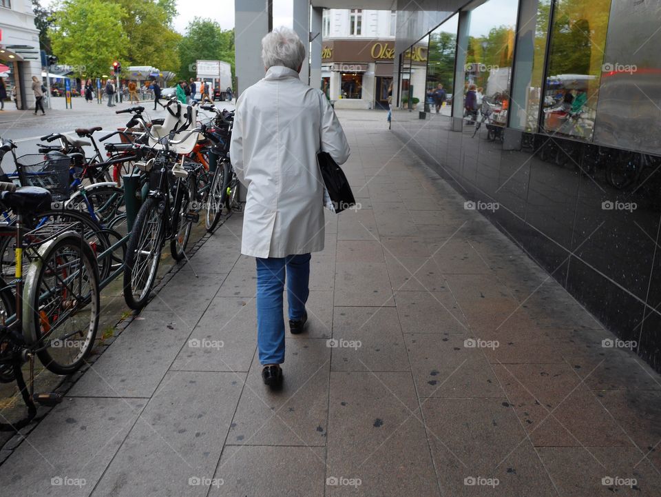 Elderly woman walking in the city