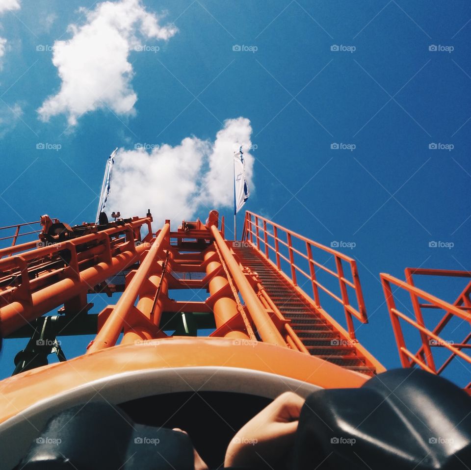 Roller coaster against blue sky