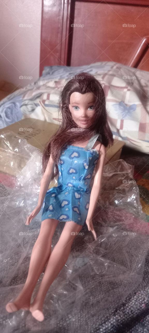 Cute barbie doll on a bed