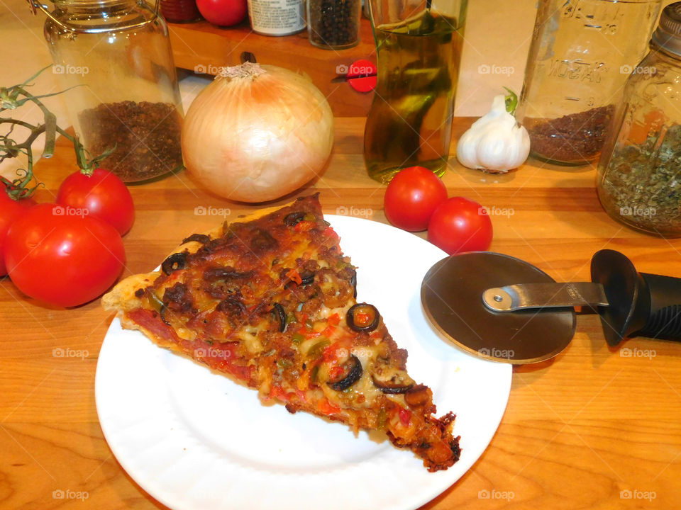 Delicious and nutritious homemade pizza with fresh, colorful vegetables, meats and a variety of spices! Grab a slice!