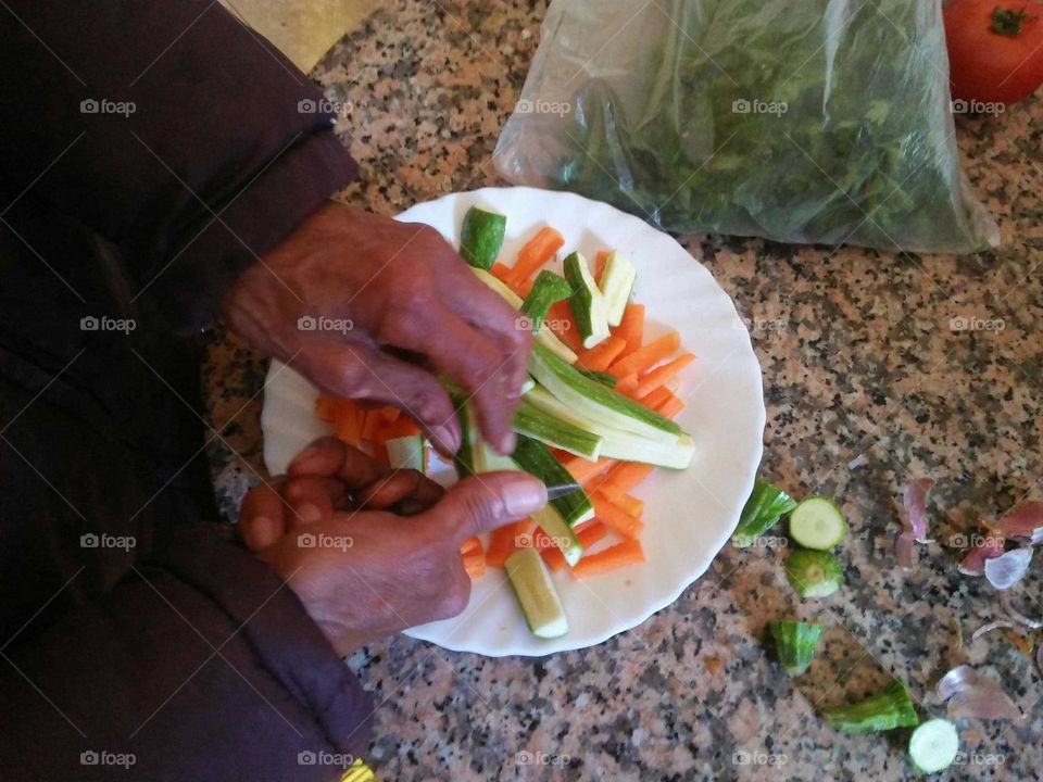 Hands mading salad.