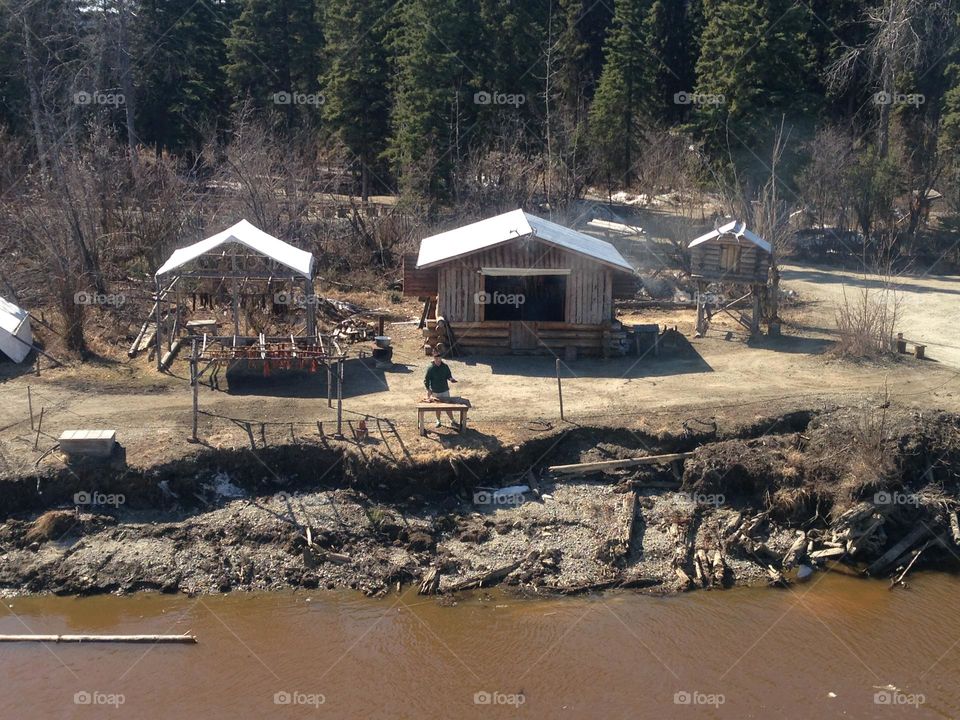 Small Fishing Hut’s and Fisherman cleaning Fish at Fishing Post along the Chena River in ALASKA. 