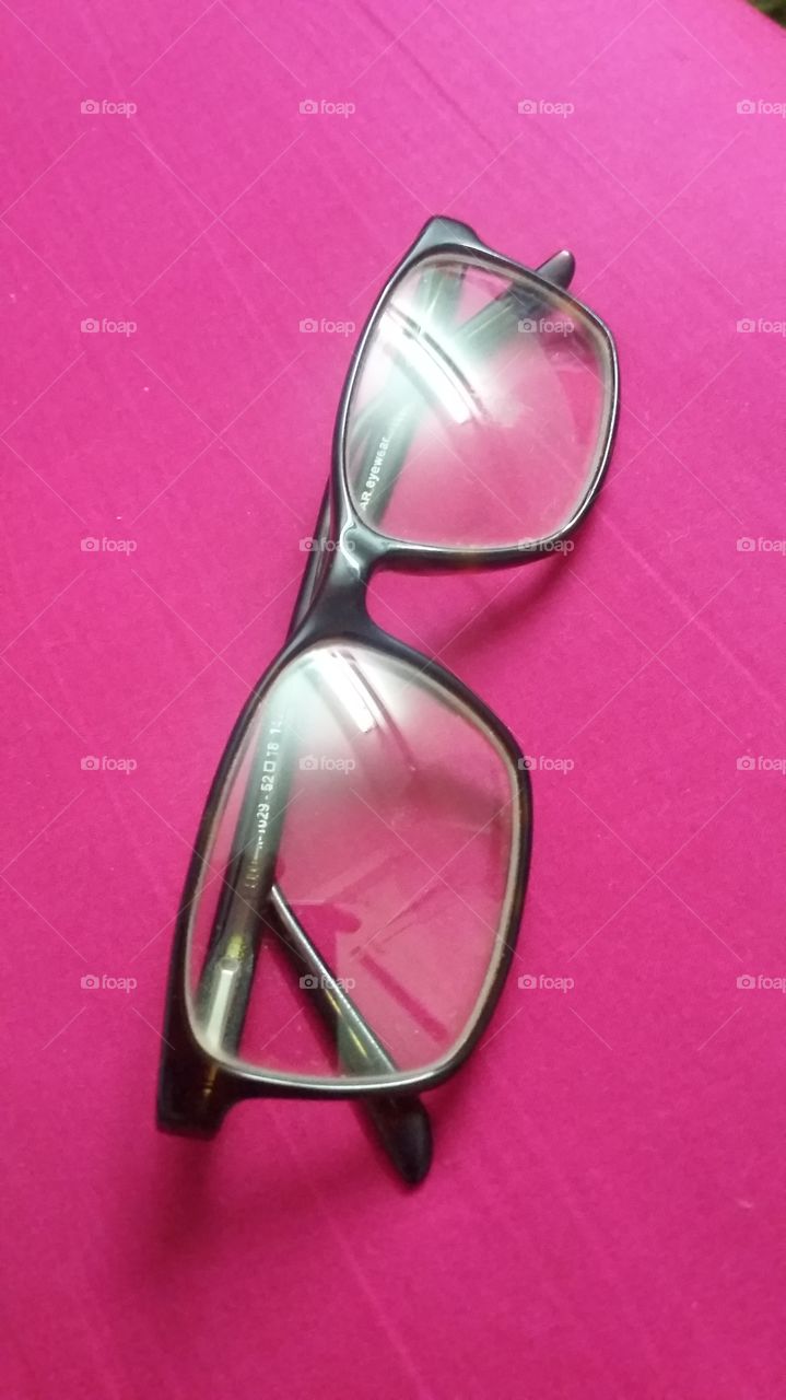 gents eyeglass on pink background
