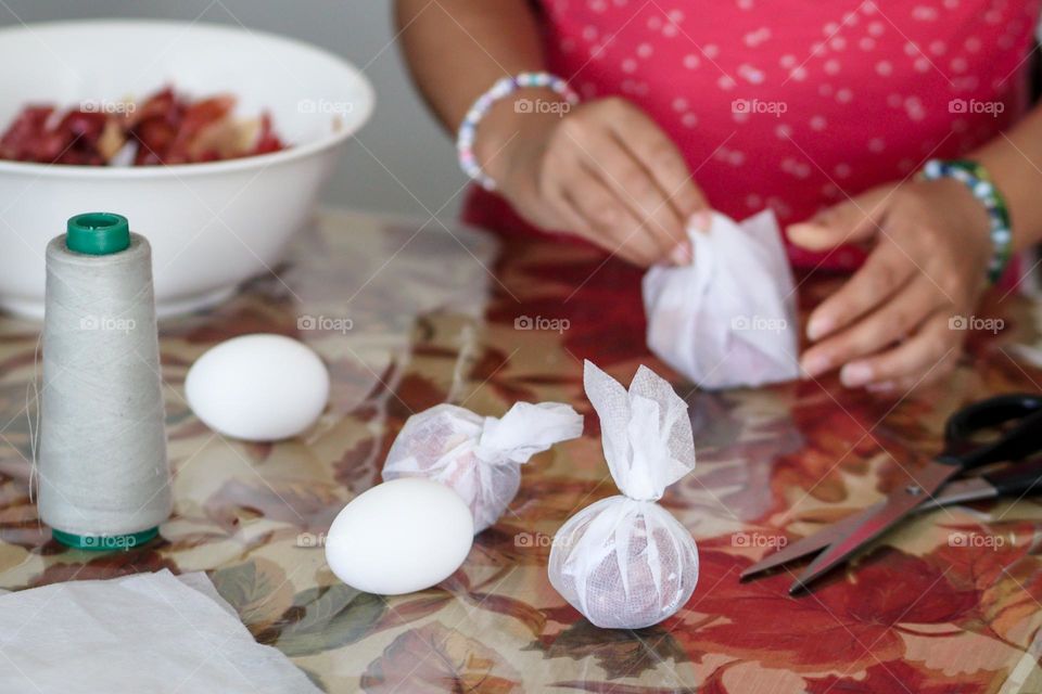 Child is coloring eggs using natural materials