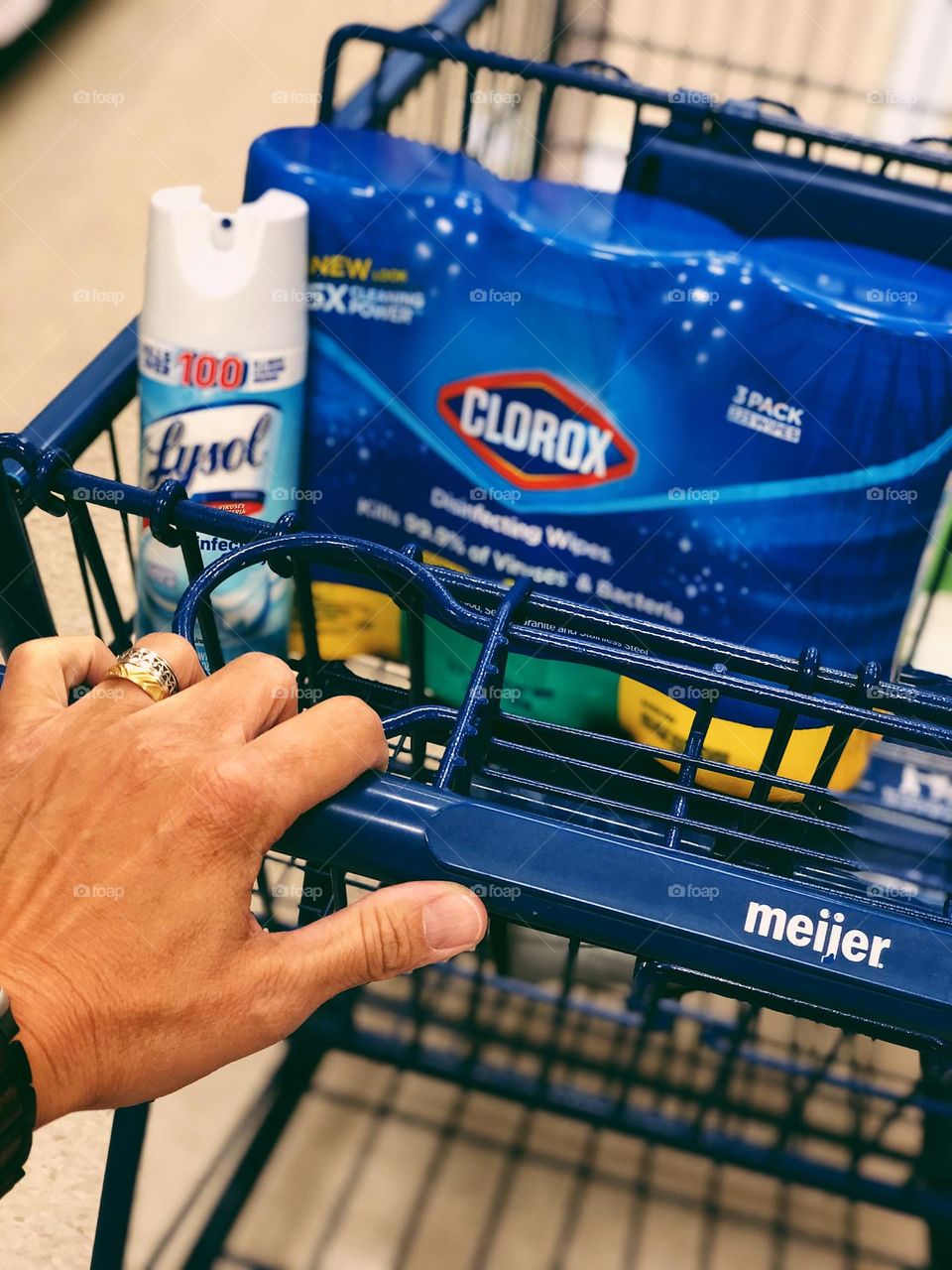 Woman’s hand pushing cart in Meijers, shopping for supplies, Covid cleaning supplies, protection from diseases, Covid protection in stores, woman shopping