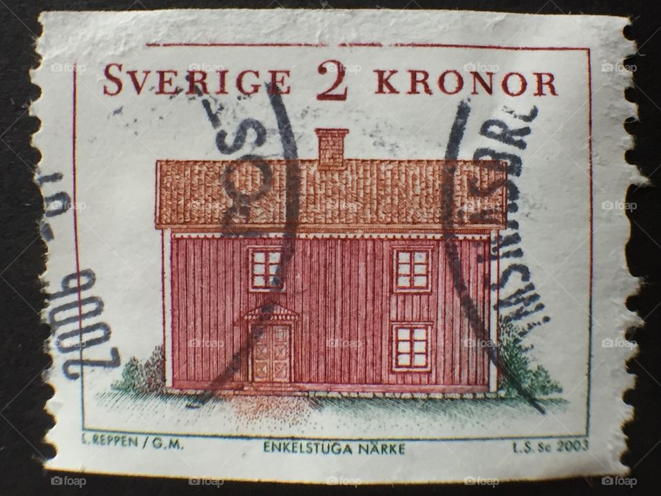 Swedish 2 kronor postage stamp showing traditional Wood timber house. Rubber stamped