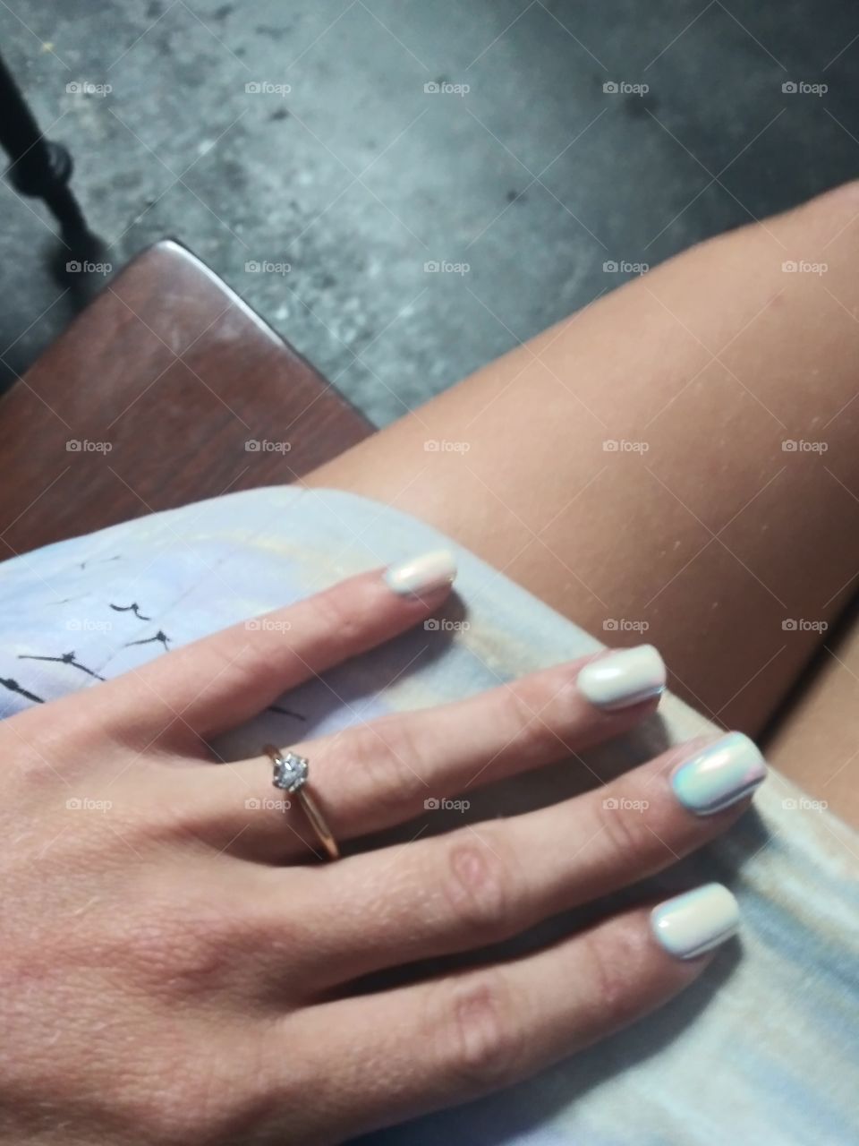 woman showing off her manicure and engagement ring
