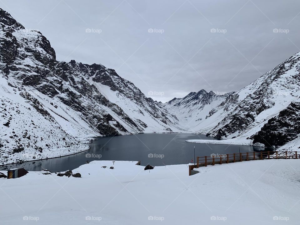 Frozen lake between snow-capped mountains