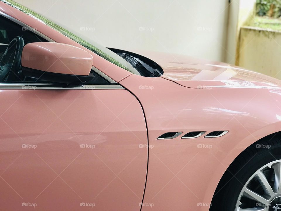 Light pink colour car at parking 