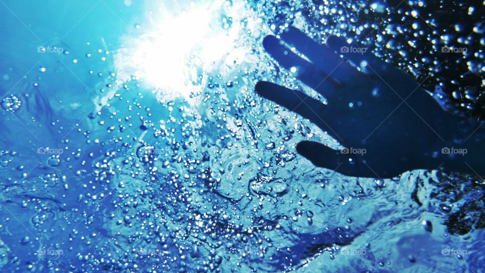 Close-up of human hand underwater