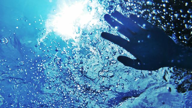 Close-up of human hand underwater