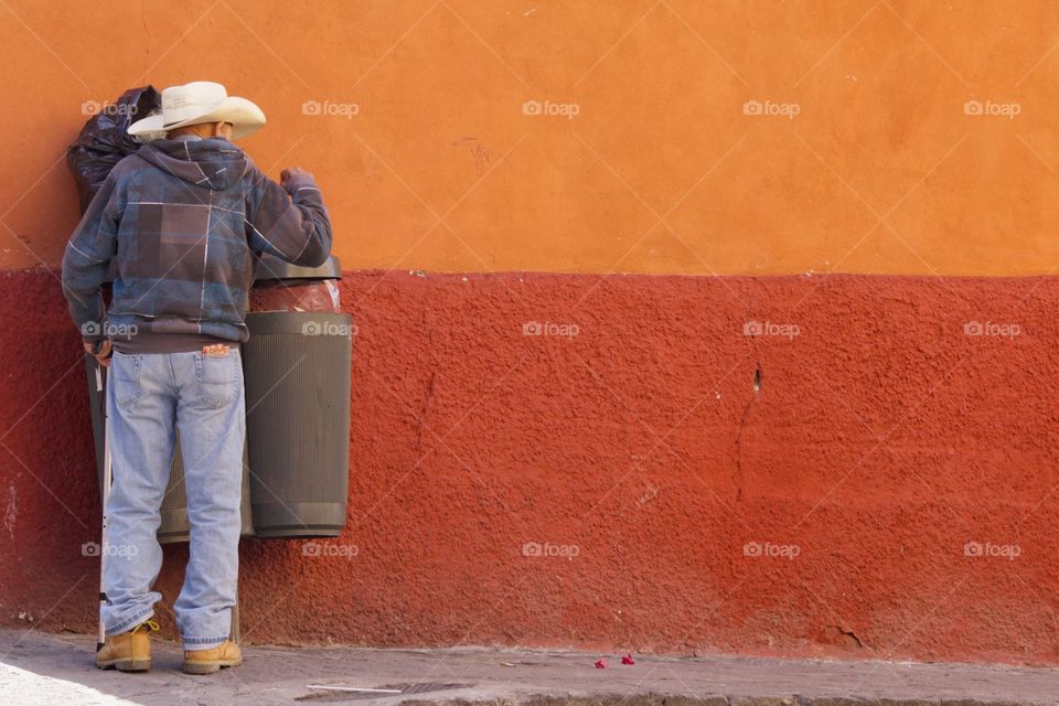 Cowboy throwing rubbish in trash can, San Miguel de Allende