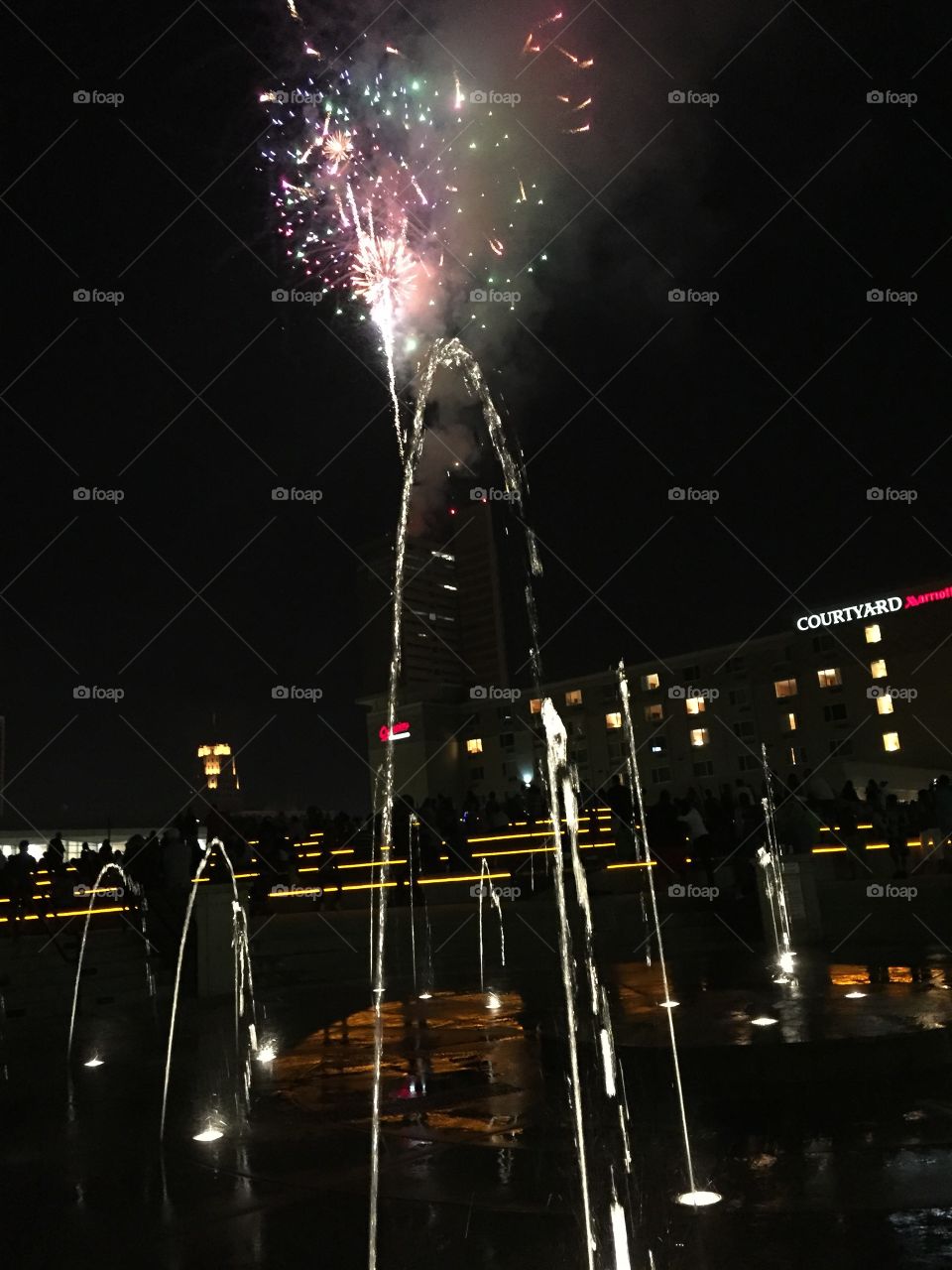 Fireworks from water. View of the fireworks with the fountain in the forefront.