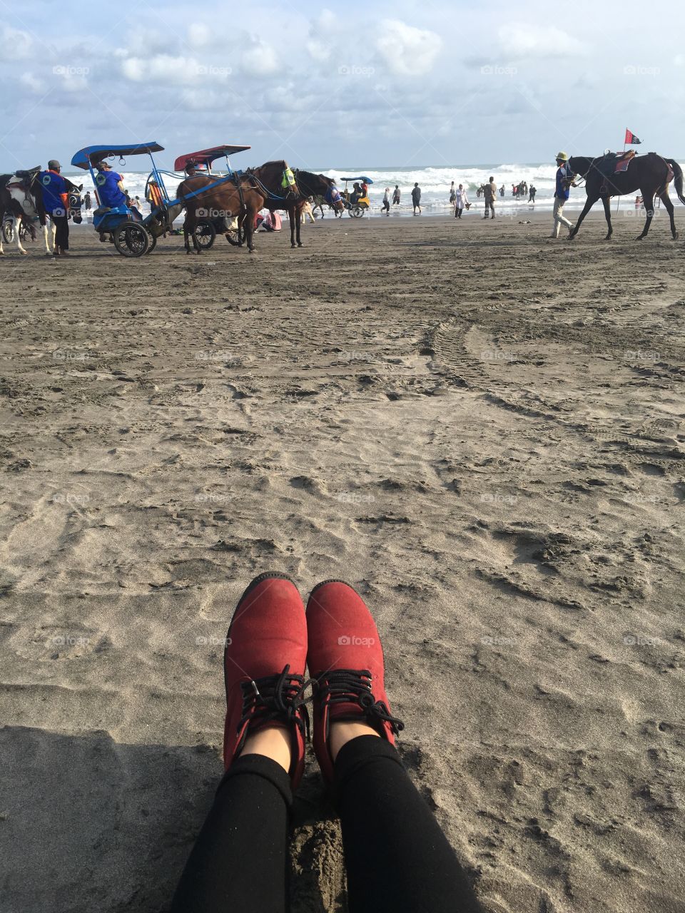 Red boots on the sand