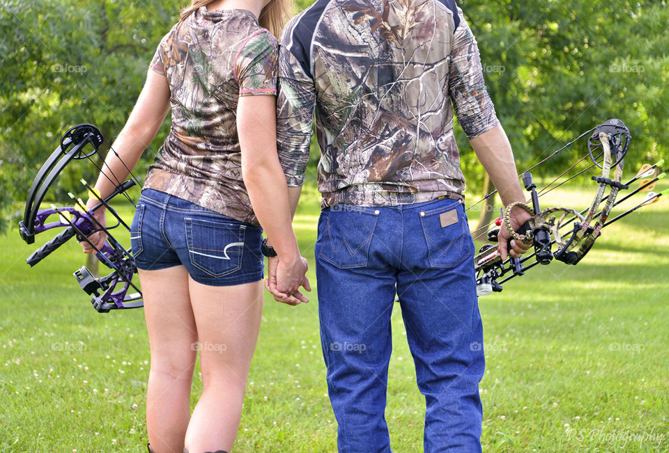 bow hunting. couple incorporated their love of bow hunting into their engagement session