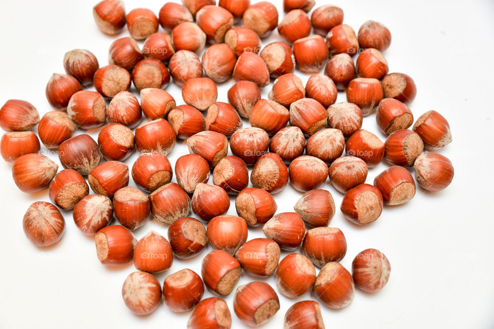 Hazelnuts over white background