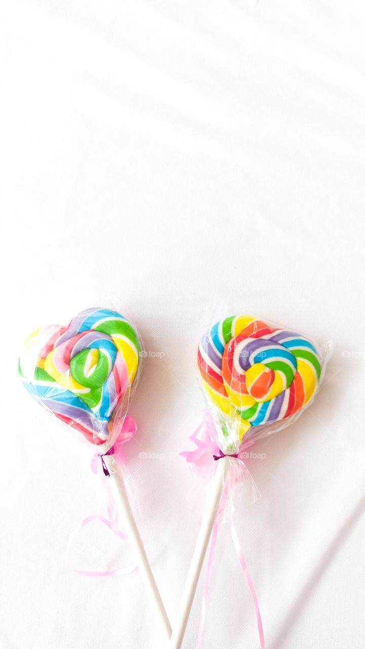 two rainbow lollipops