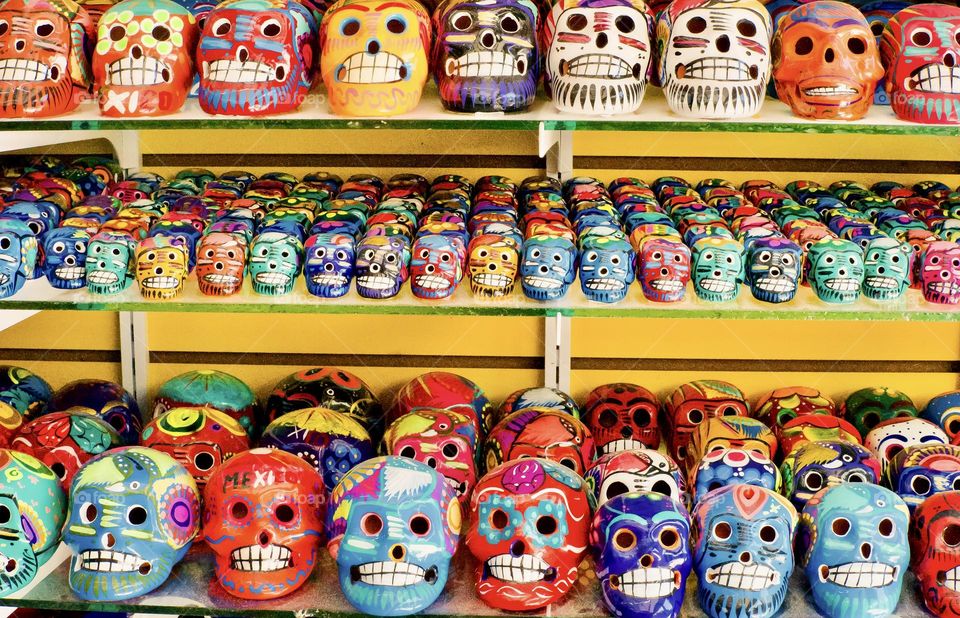 Colourful painted ceramic skulls at the market.