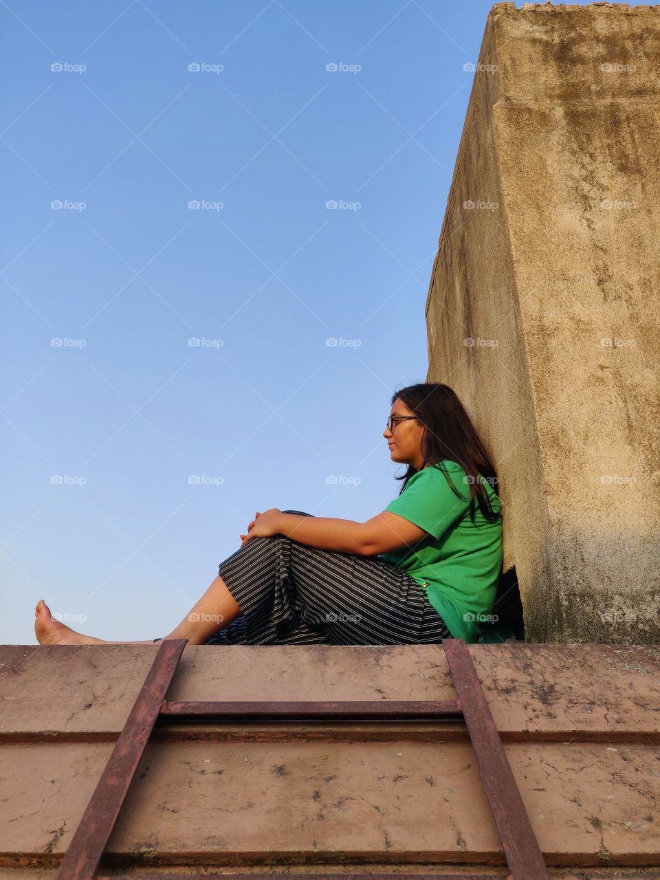 young girl..sitting on the rooftop... pondering about life...