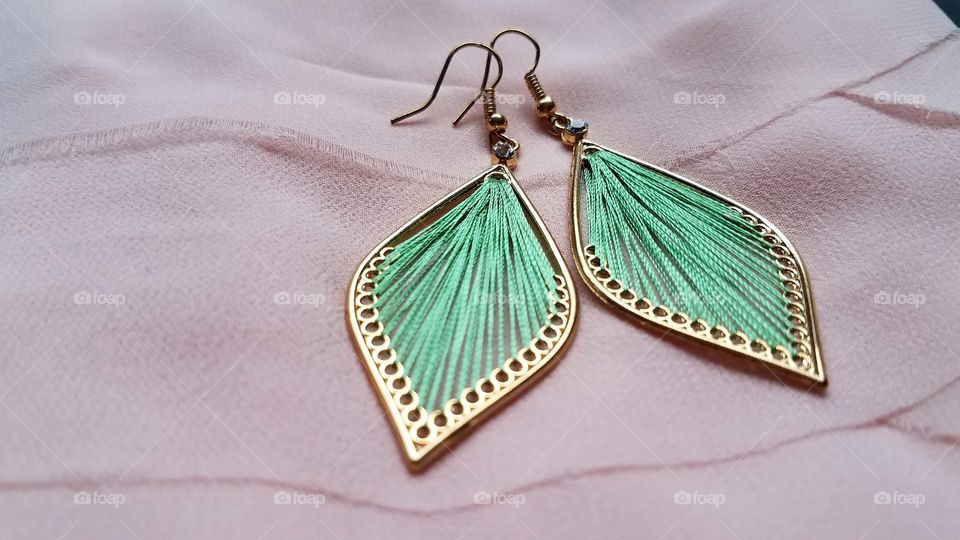 Pair of earrings on cloth