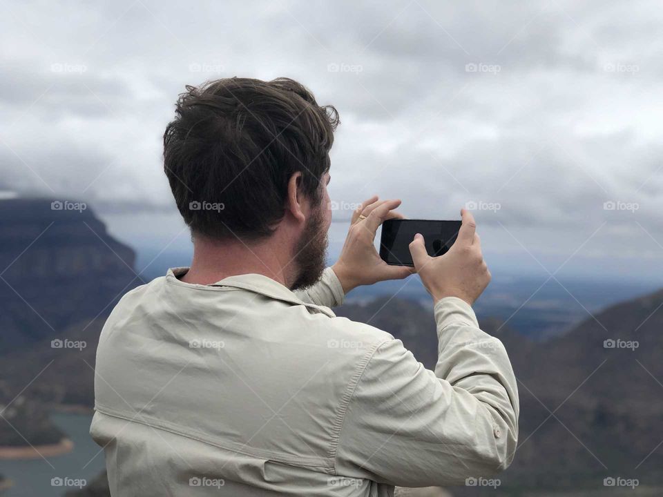 Man taking pictures of great view