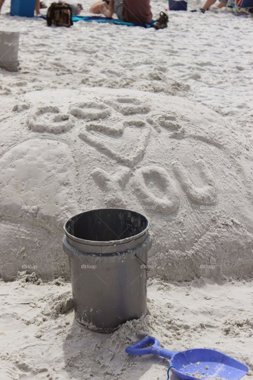 god loves you. sand art on sarasota beach in florida