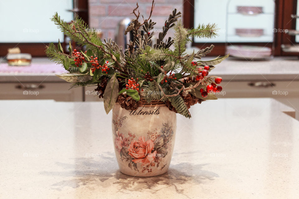 decorative vase on a table with a bouquet of forest