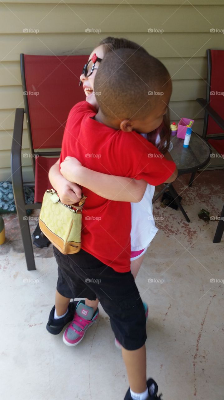 Two best friends -after being divided by miles, rather than by color- finally reunited and captured sharing in a most heart-warming, beautiful, and empowering hug.
