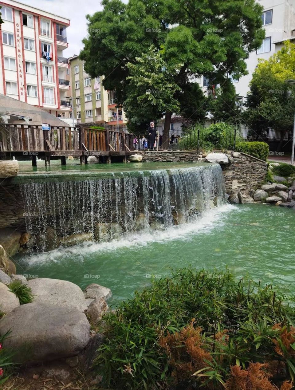 The tranquil ambiance and the gentle cascade of water create a serene and enchanting scene. It's truly a breathtaking spot to be in.