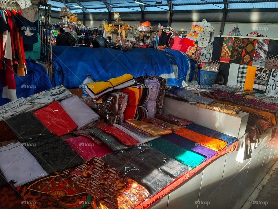 Colorful textile products displayed in the traditional marker in Sanur Village - Bali