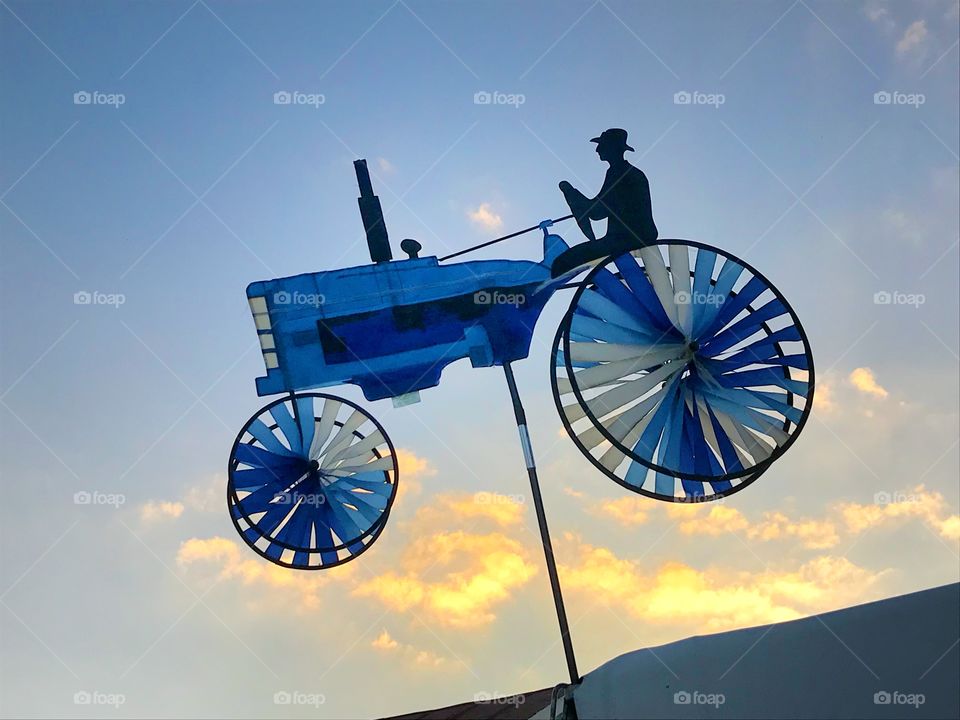 Blue paper tractor against sky